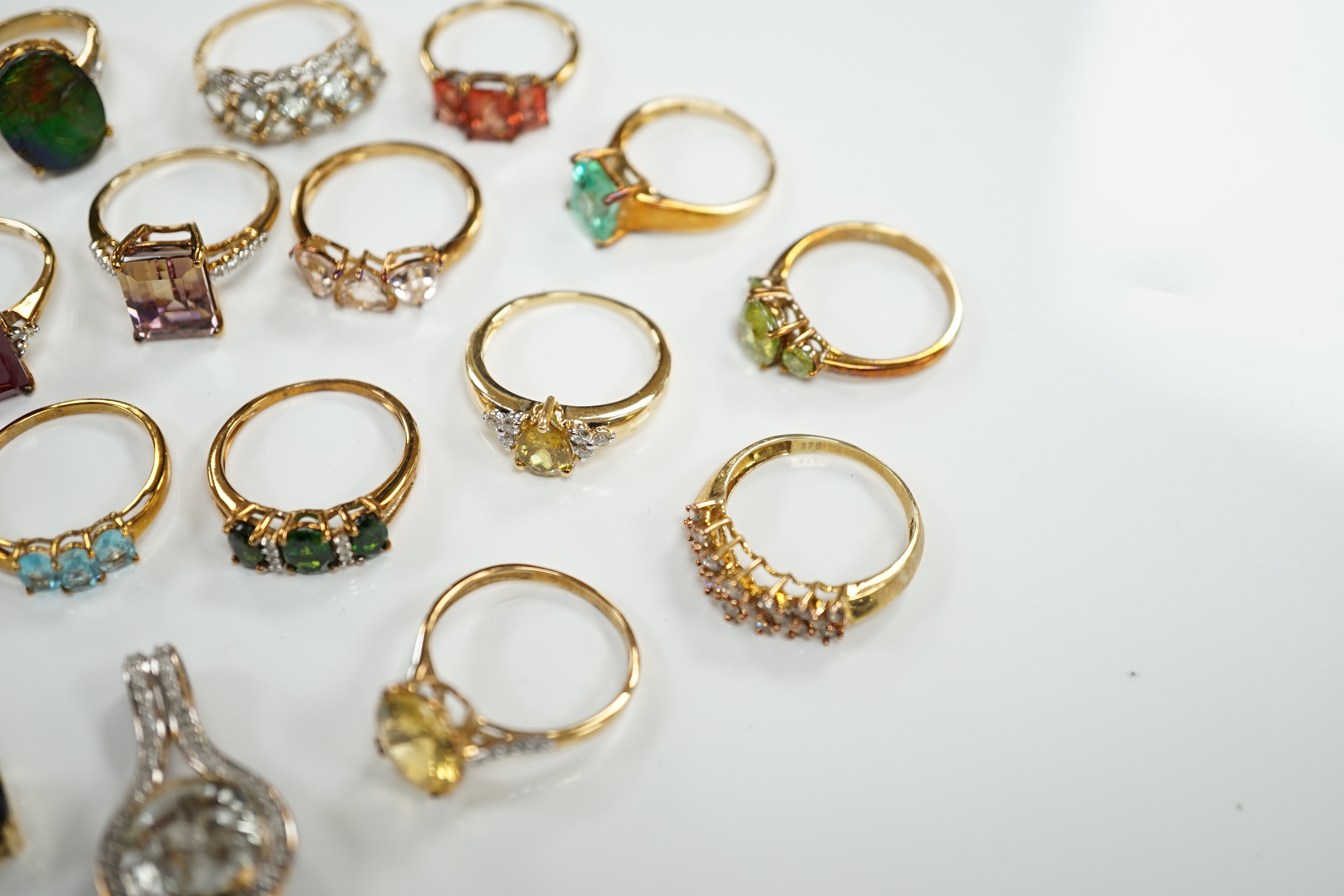 Thirteen assorted modern 9ct gold of 9k and gem set dress rings and a 9ct gold and gem set pendant, gross weight 40.2 grams, together with an 18ct gold, gem and diamond chip set target pendant and an 18ct gold and gem se